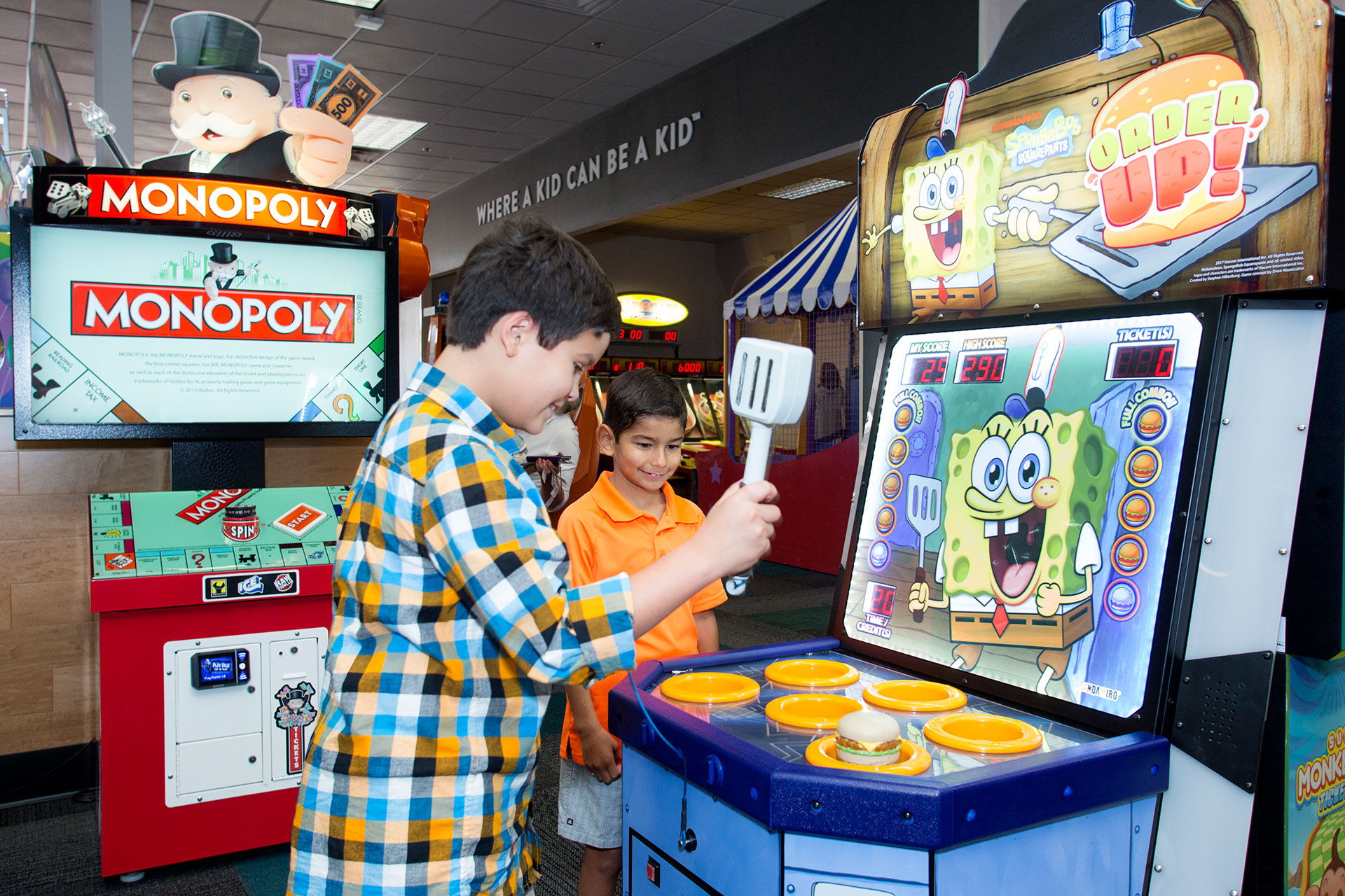 Two kids playing arcade game